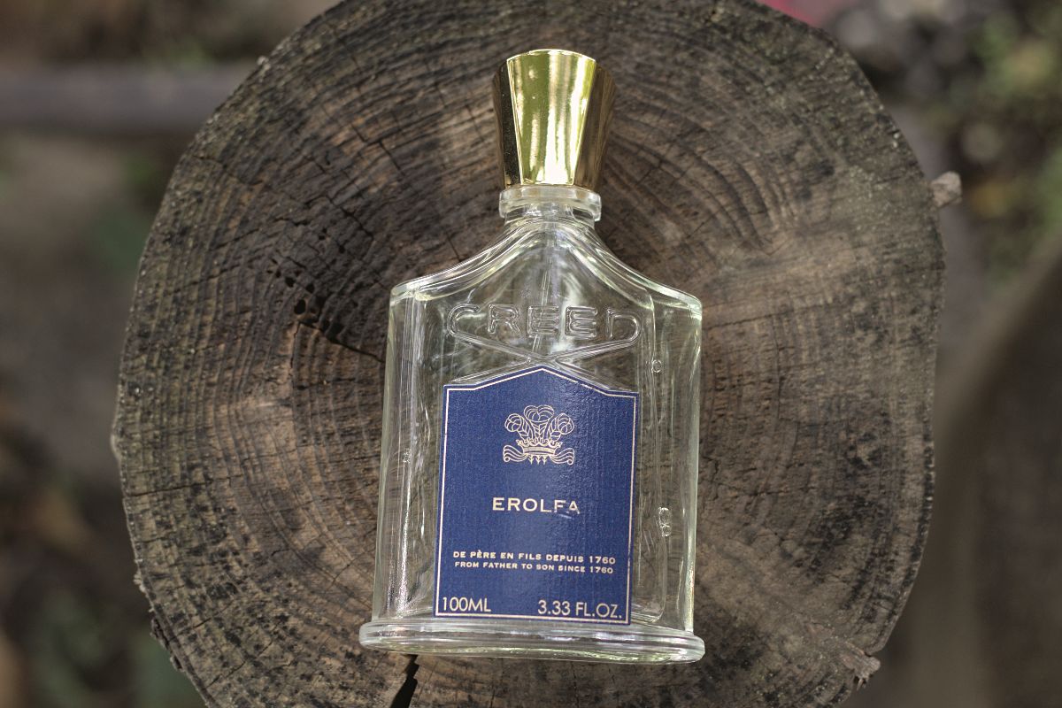 Creed Erolfa bottle on a wood log Creed Erolfa Review (2024): Forgotten Legend Creed Erolfa - bottle on a wood log